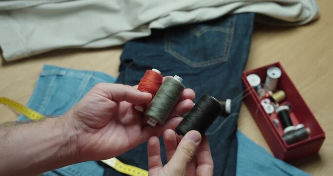 Fashion Designer Selecting Colorful Threads for Sewing Project