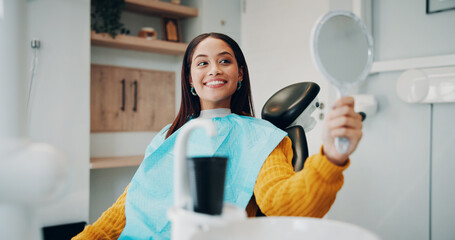 Woman, dentistry and smile with mirror for dental surgery, teeth whitening and treatment in clinic....