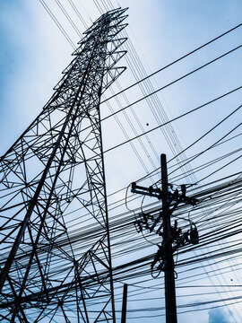 Electricity Transmission Tower and Power Lines Silhouette Against Evening Sky