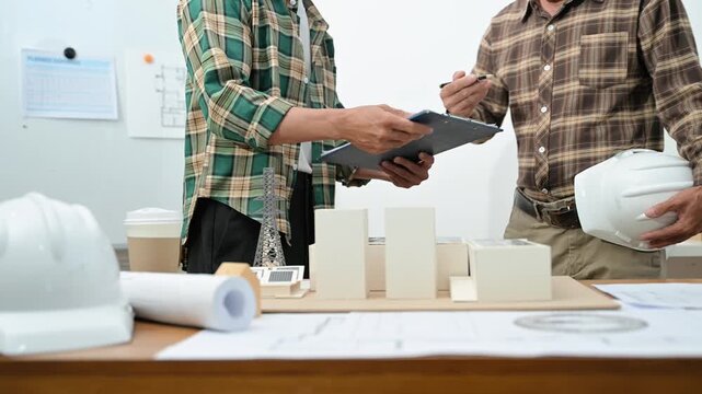 Two professional architects shake hands after signing a contract for a renewable solar energy project, finalizing the sustainable infrastructure deal