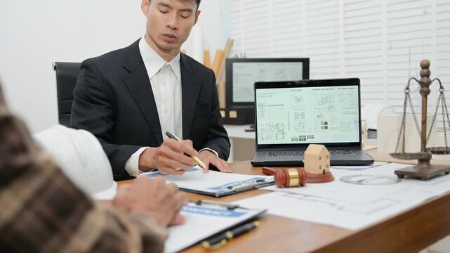 Professional lawyer and contractor discussing a real estate construction contract, reviewing architectural blueprints and legal documents
