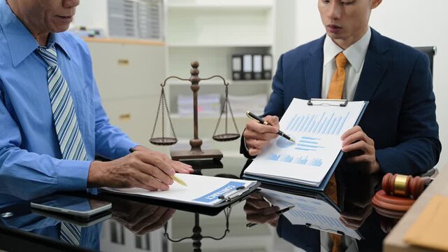 business people and lawyers discussing contract papers sitting at the table. Concepts of law, advice, legal services.