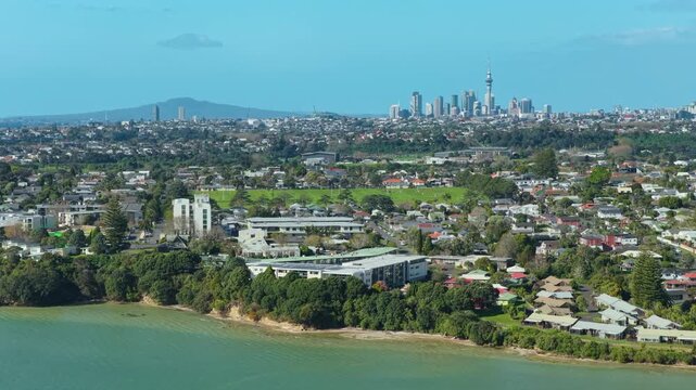 Scenic aerial view of the Auckland skyline and coastal suburb of Pt Chev in Auckland, New Zealand, showcasing the urban landscape and harbor.