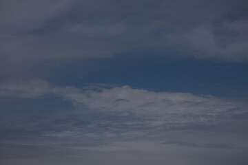 Wispy clouds drift across a deep blue sky on a hazy day © MARIA – Nature