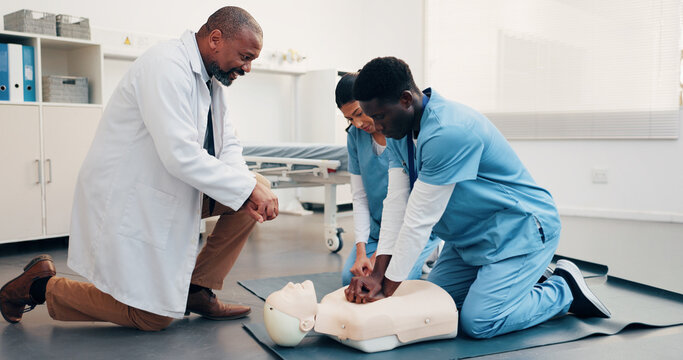 Healthcare, team or dummy in training for cpr, compression technique or residency practical. Man, physician or resident doctors with mannequin, life saving procedure or clinic simulation in first aid