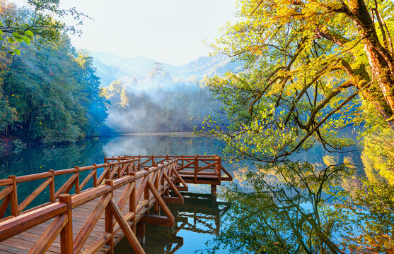 Autumn forest landscape reflection on the water with wooden pier - Autumn landscape in (seven lakes) Yedigoller (Yedig&ouml;ller) Park Bolu, Turkey