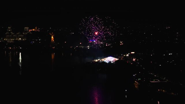 Low light view of fireworks on Grand Sataabdi Utsav in People's Plaza with Necklace Road and Hussain Sagar Lake at hyderabad, telangana, india. night time, arc shot, drone shot, 4k.