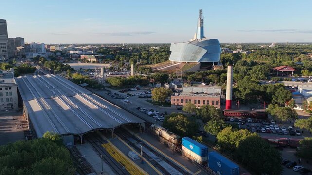 Downtown Winnipeg, freight train entering the Forks, 4K drone shot