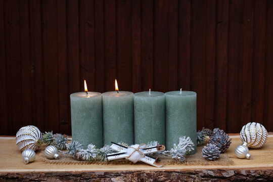 Modern country-style Christmas decor for the Second Sunday of Advent, featuring sage-green candles on rustic wood and space for text.