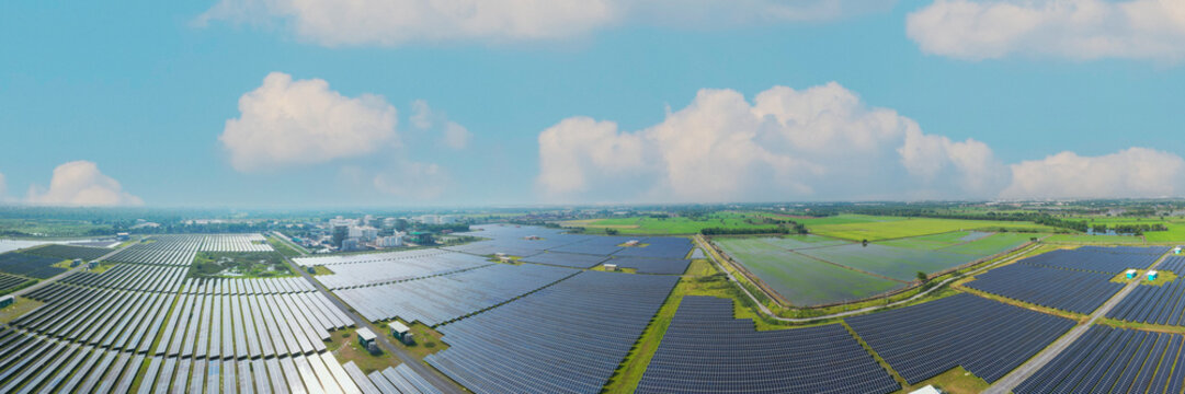 chemical refinery plant and solar panel farm. Sustainable energy concept with industrial factory and solar power plant. Drone view of large oil storage tanks, container and solars farm. Industrial lan