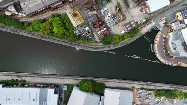 Direct overhead drone aerial view of a factory landscape. Heavy machinery, industry, manufacturing, work site, corporate.