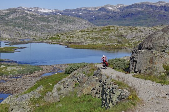 Cyclists on an old path, in the background mountains and fells, cycle tour, summer, adventure, Rallarveien, Scandinavia