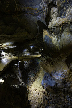 Illuminated subterranean cavern chamber, karst limestone formations, and tourist walkway inside the Lurgrotte Peggau cave system in Styria, Austria
