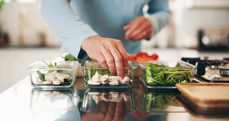 Fotobehang Onderzeeër Person, hands and diet with food container in kitchen for healthy meal prep or ready made snack. Culinary artist, vegetables or chef with vegetarian ingredients for wellness or eating plan in home  © peopleimages.com