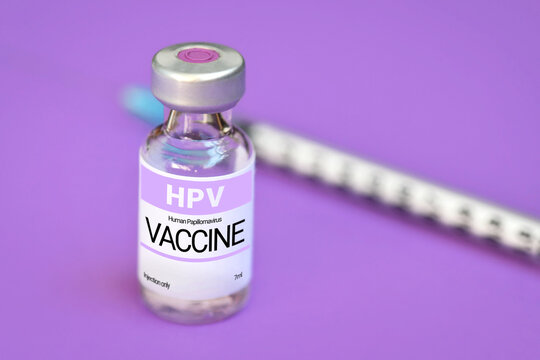 HPV Human Papilloma virus vaccine vial with syringe on purple background