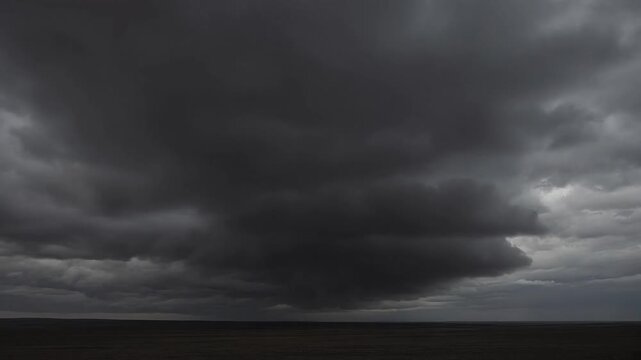 Dark, Ominous Storm Clouds Gathering Over a Calm Horizon