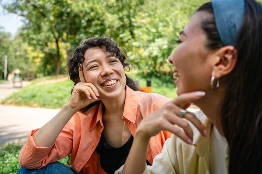 Two students share friendship and conversation in city park