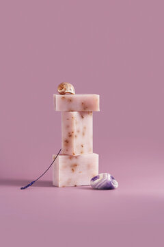 Handmade lavender soap bars with shell and stone still life