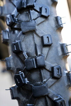 Close-up of rugged motorbike tire tread and traction lugs