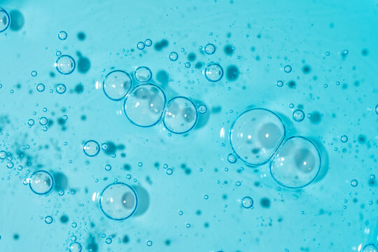 Blue gel texture with transparent bubbles and fluid pattern