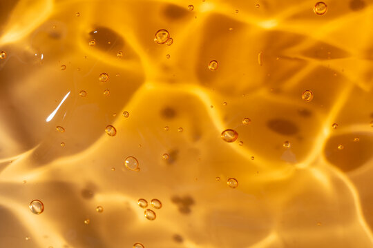 Golden gel texture with suspended air bubbles