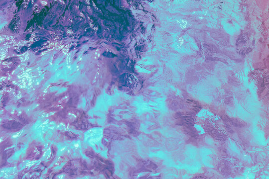 Abstract turquoise and purple water ripple texture background