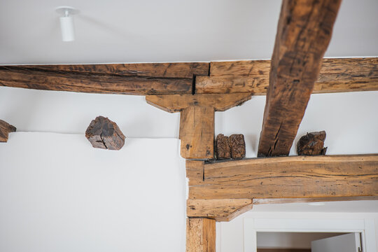 Rustic wooden ceiling beam in modern apartment interior