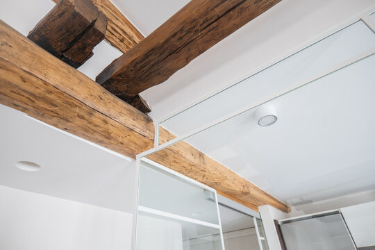 Modern apartment interior with exposed wooden ceiling beam