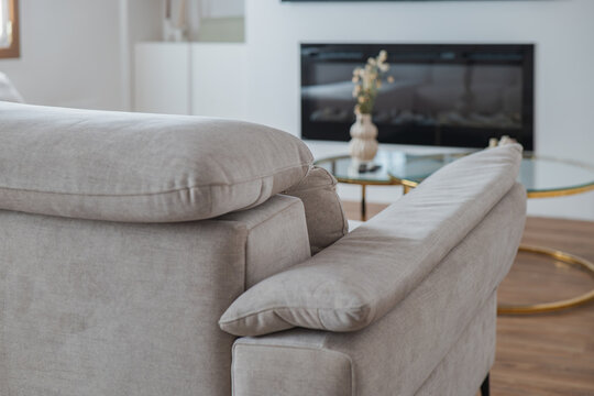 Modern apartment living room with gray sofa and fireplace