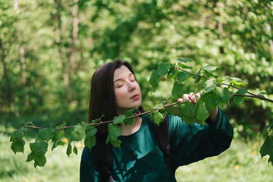 Woman touching tree branch in A peaceful forest