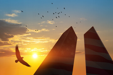Silhouette of Towers with soaring eagle and flying birds at sunset. 09.11.2001 American Patriot Day...