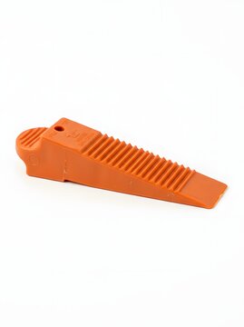 Orange wedge tool for construction and diy projects isolated on white