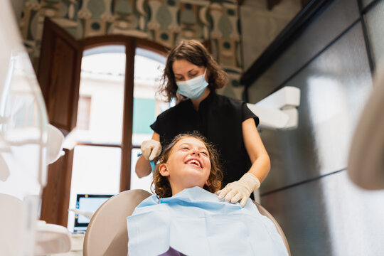 Happy young girl receiving dental check up