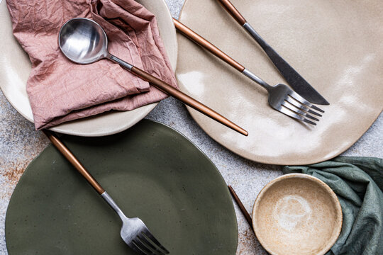 Rustic table setting with ceramic plate and copper cutlery
