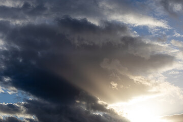 Obraz premium Dramatic sky filled with storm clouds and bright ethereal light breaking through the atmosphere