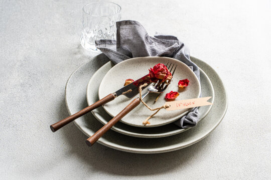 Dry red rose place setting with love letter tag