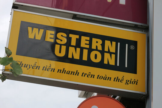 Western Union cross border cash remittance service logo signboard close up on city street in Da Nang, Vietnam - January 23, 2026