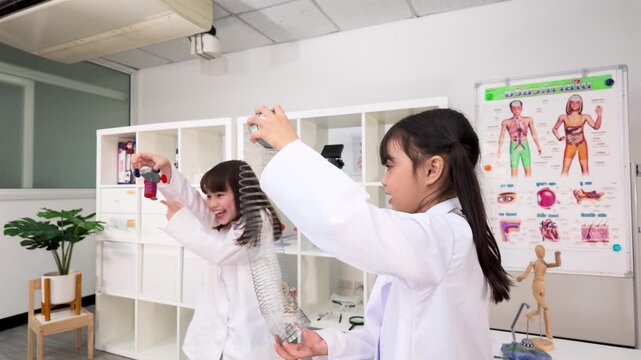 Schoolgirls in Lab Coats Playing with Slinky Toy in Science Classroom