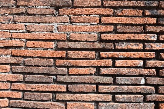 Weathered red brick wall texture, close-up