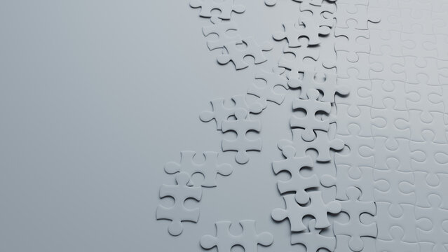 Partially Completed White Jigsaw Puzzle Wallpaper with scattered Pieces. Complexity Concept with copy-space.