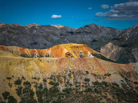 Yellow off road truck on a colorful mountain pass