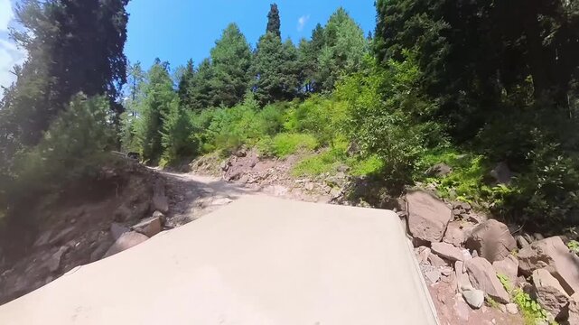 A jeep ascending on a curvy path of mountainous valley.  360 camera view