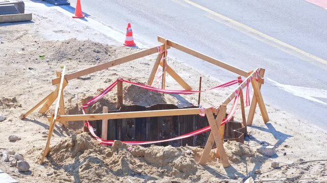 Roadworks Construction Site Overpass Pillar Foundation Excavation Pit Secured with Metal Wall Wooden Barrier and Safety Tape