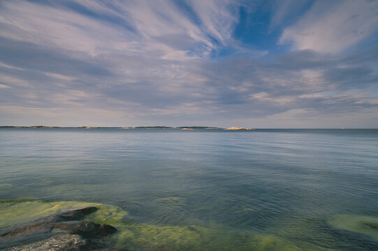 Calm Sea at Rocky Skerry Coast Under Dynamic Cloudy Sky, in sweden.