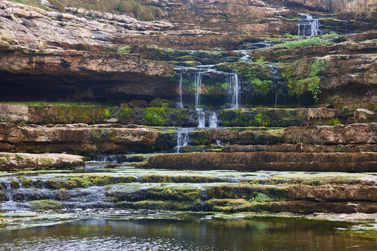 Cantabrian beautiful waterfall. El Bolao cliffs. Cantabria, Spain