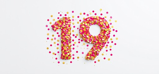 Naklejka premium Number 19 crafted from gold and red confetti arranged neatly on a white background for festive celebrations.