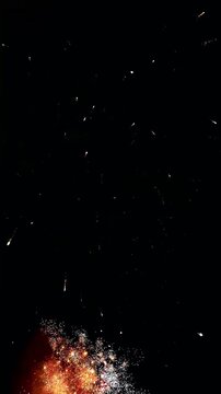4K. Vertical loop seamless of real fireworks background golden shining fireworks with bokeh lights in the night sky. glowing fireworks show. New year's eve fireworks celebration multiple colors 