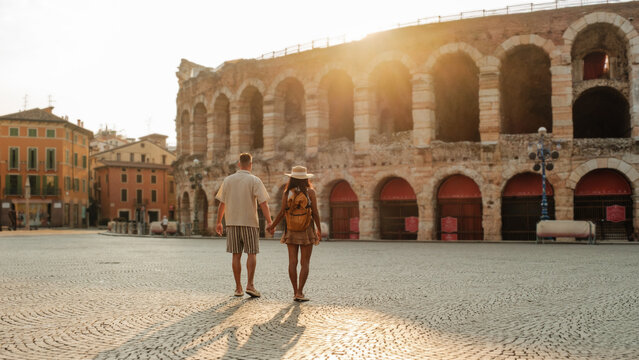 Couple enjoying a romantic stroll at Veronas ancient amphitheater during sunset