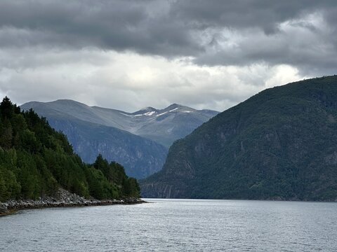Broad fjord with mountains beneath overcast skies, Norddalsfjorden, M&oslash;re og Romsdal, Norway, August 2025