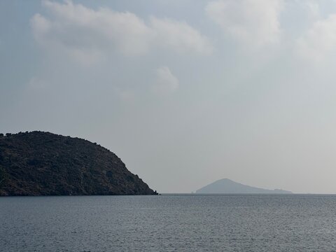Island silhouettes viewed across calm Mediterranean Sea, Skala, Patmos, South Aegean, Greece, November 2025
